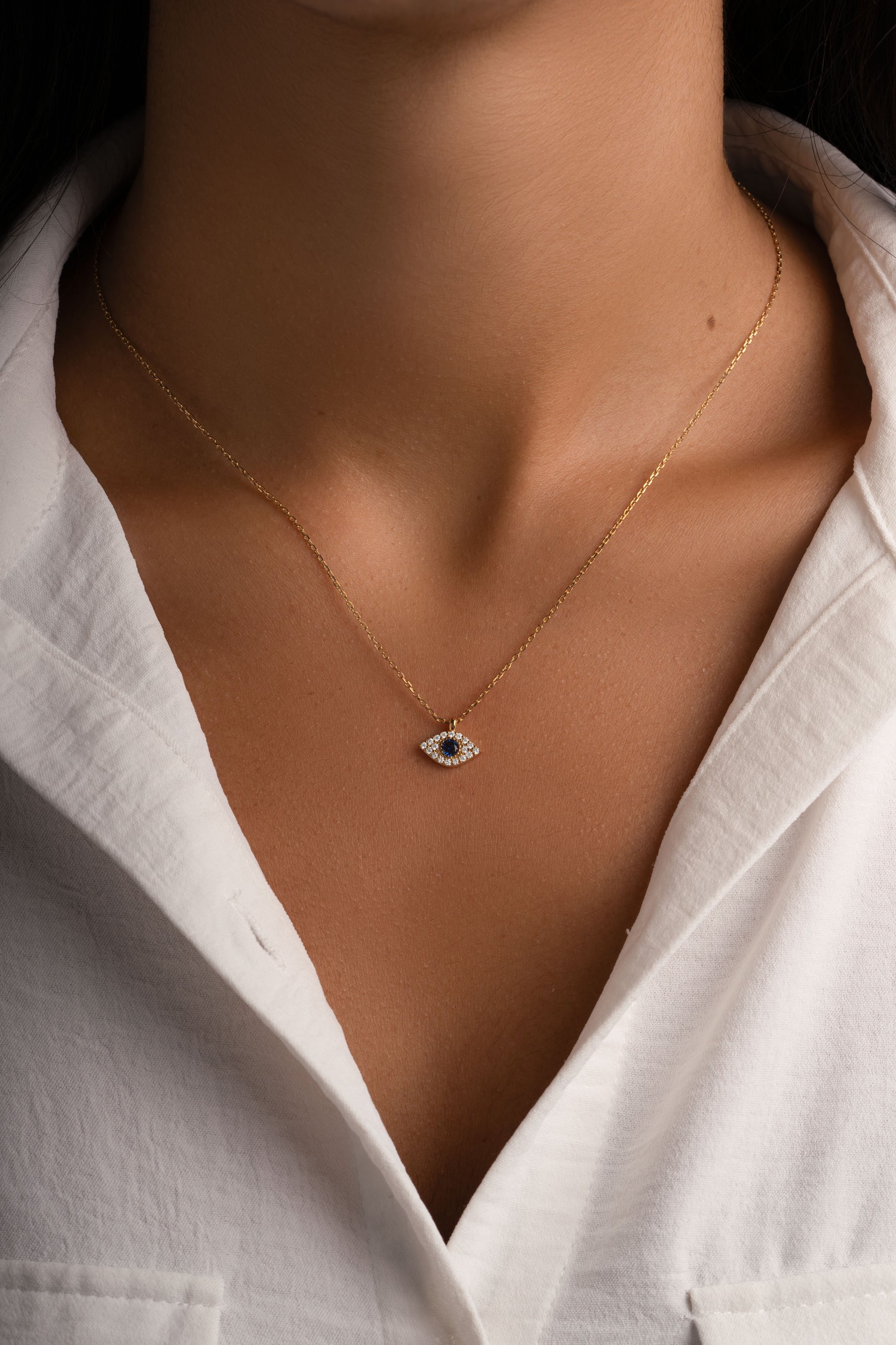Gold sapphire evil eye necklace from Sami Jewels featuring a vibrant blue gemstone pendant on a delicate chain.
