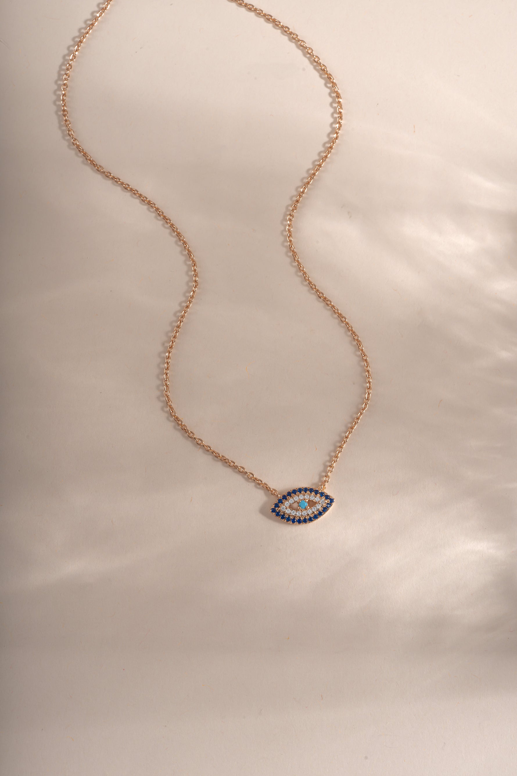 Sapphire Evil Eye Necklace in rose gold from Sami Jewels featuring a blue sapphire evil eye pendant on a delicate chain.