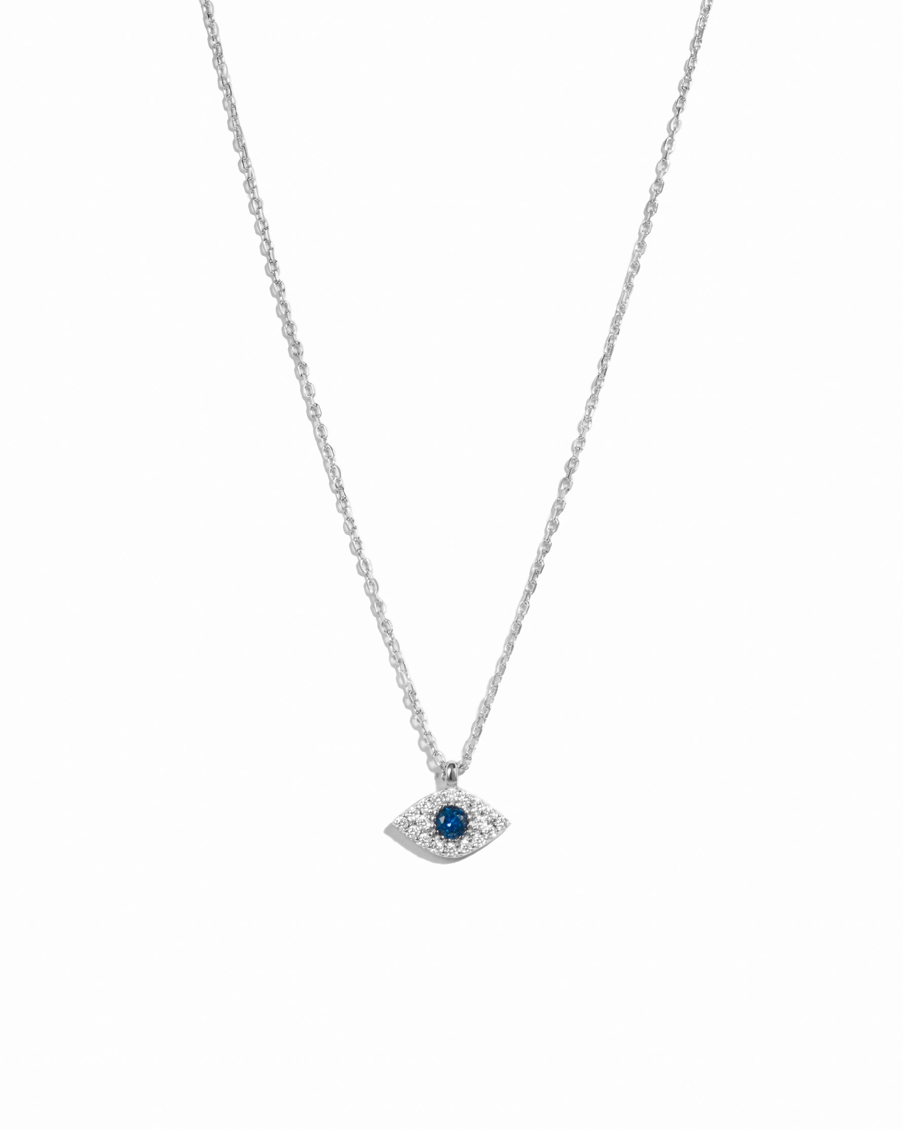 Sterling silver Sapphire Evil Eye Necklace featuring a blue sapphire charm on a delicate chain, displayed against a white background.