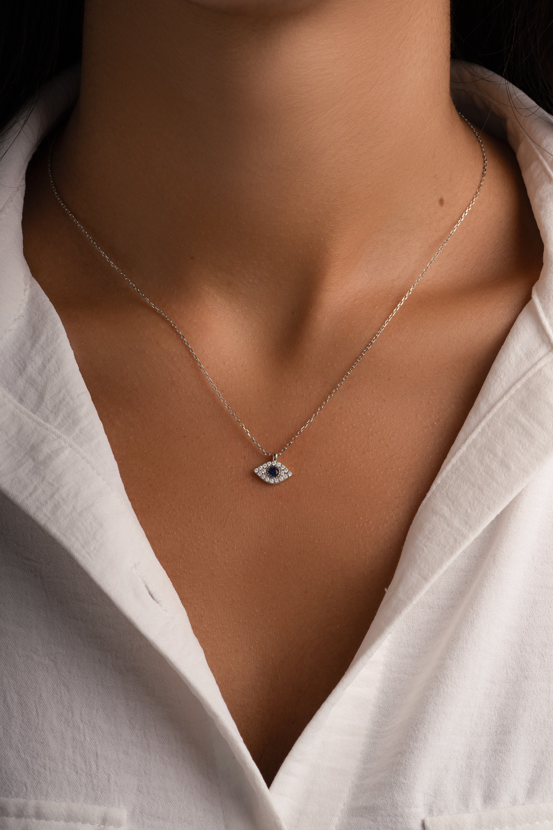 Sterling silver Sapphire Evil Eye Necklace from Sami Jewels featuring a vibrant blue sapphire eye pendant.