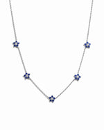 Sapphire Flower Necklace by SJ Faire featuring a sterling silver chain and a sapphire flower charm.