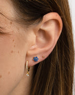 Sami Jewels sapphire flower stud earrings featuring gold settings, showcasing elegant floral design and sparkling blue sapphires.