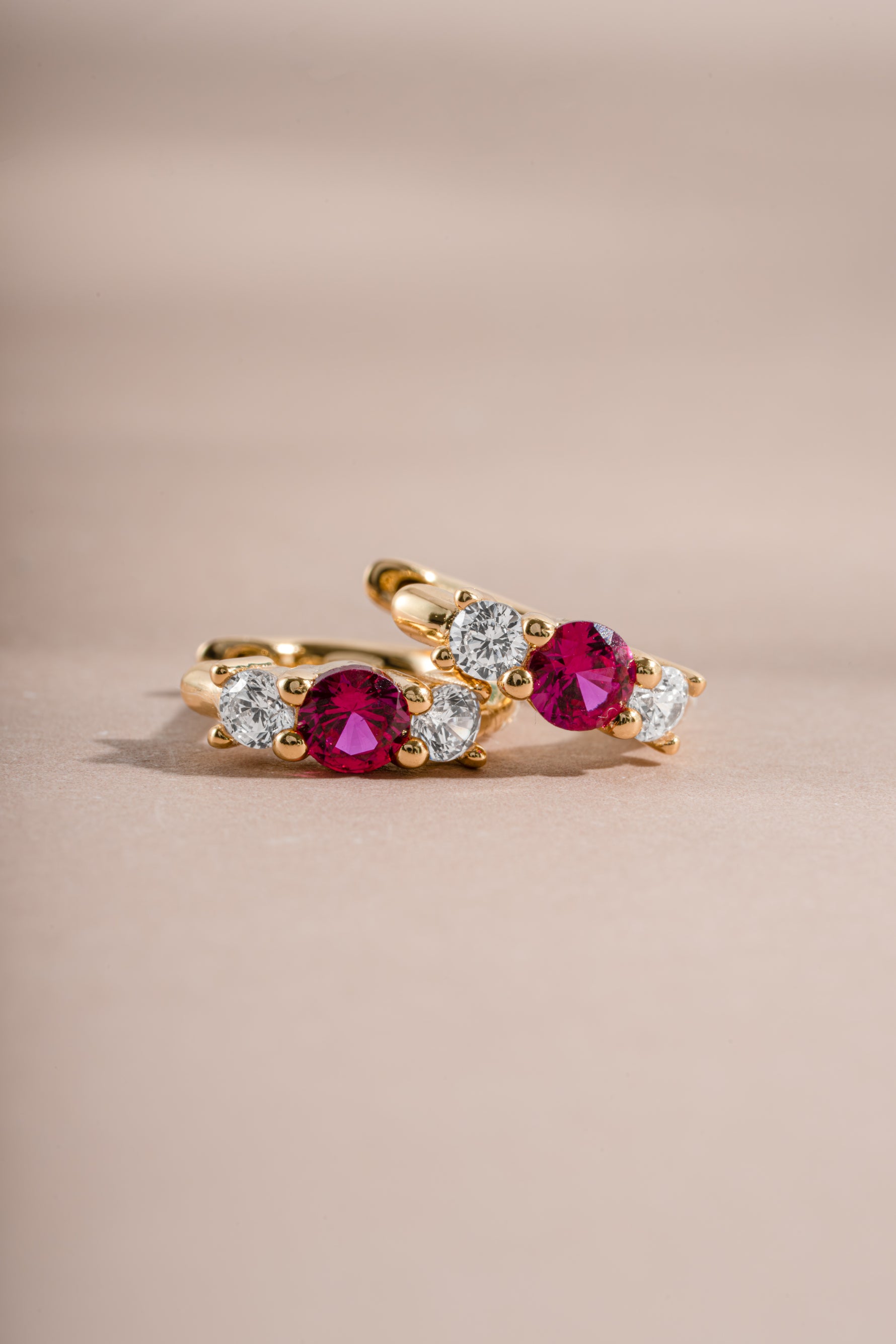 ruby three stone huggie earring closeup