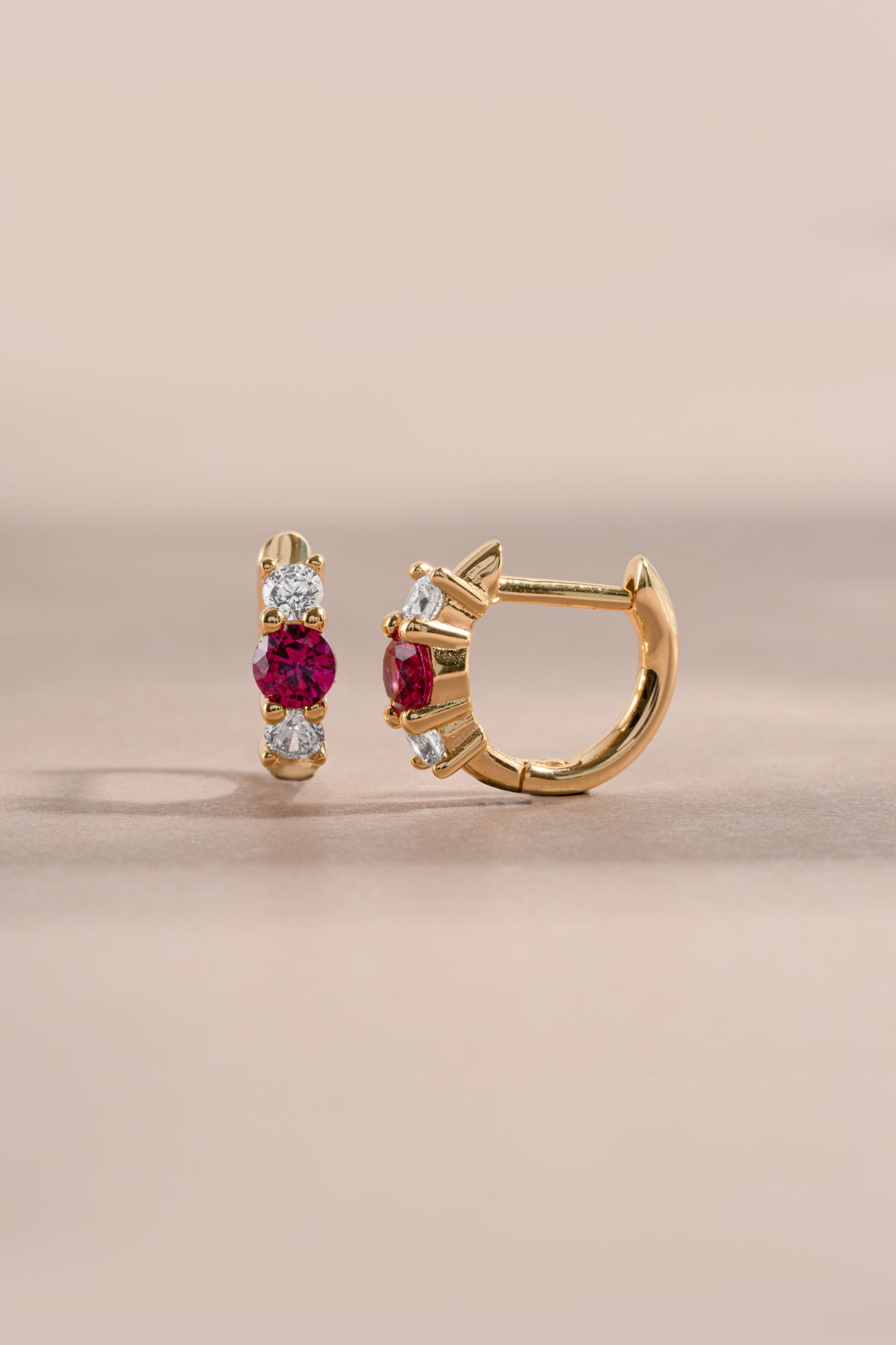 ruby three stone huggie earring gold side view