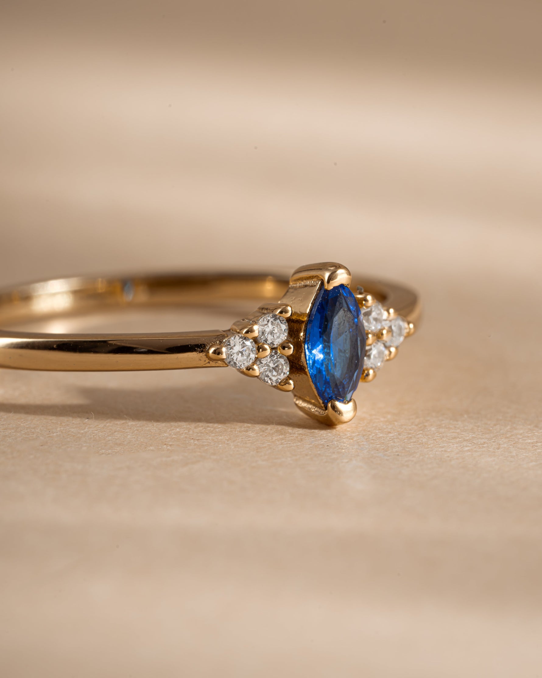 Close-up of Sami Jewels sapphire marquise ring with gold band, showcasing the elegant marquise-shaped blue sapphire gemstone.