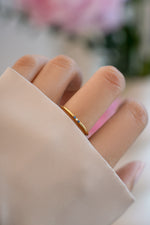 3 stone sapphire ring in gold on models hand 