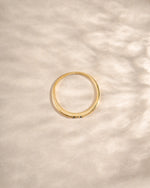 3 stone sapphire ring in gold neutral background top view 