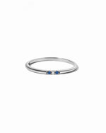 3 stone sapphire ring in sterling silver on a white background