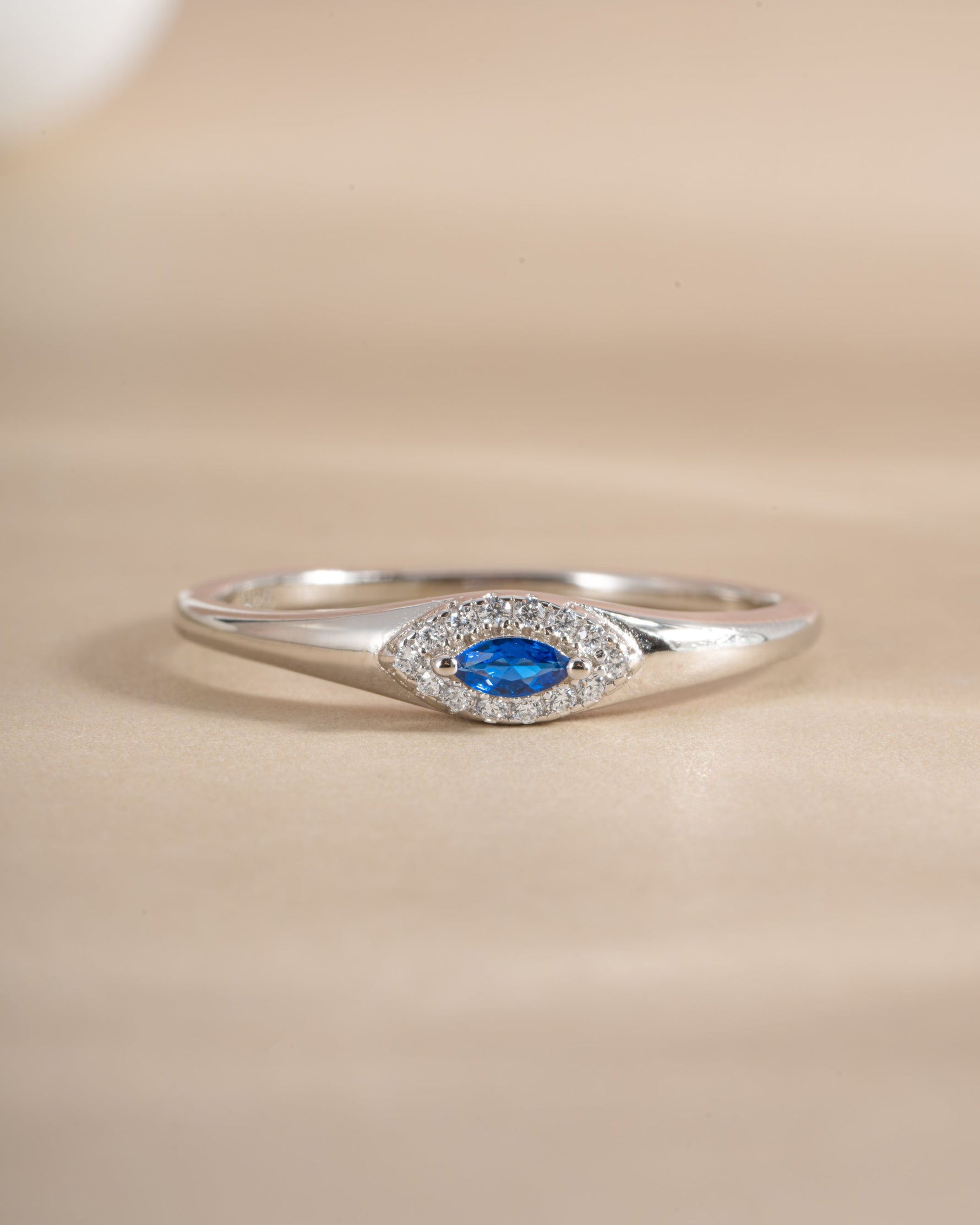 Front view of Sami Jewels sapphire evil eye ring, featuring a detailed sapphire gemstone design on a silver ring.