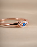 Side view of Sami Jewels sapphire evil eye ring, showcasing the detailed design and vibrant blue sapphire centerpiece.