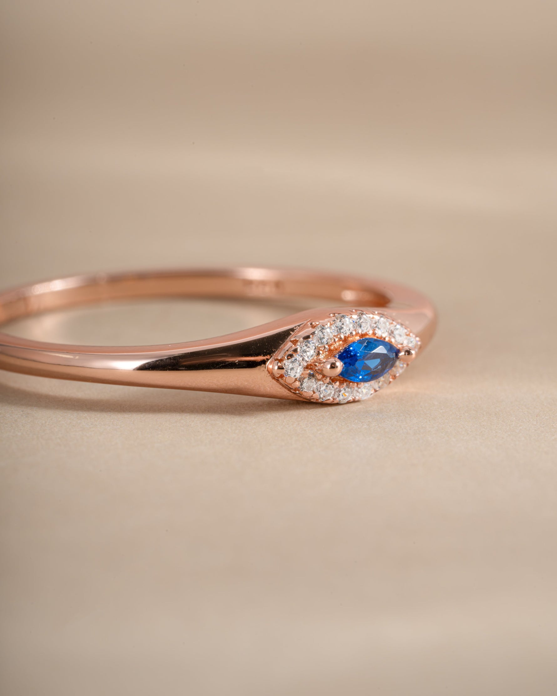 Side view of Sami Jewels sapphire evil eye ring, showcasing the detailed design and vibrant blue sapphire centerpiece.
