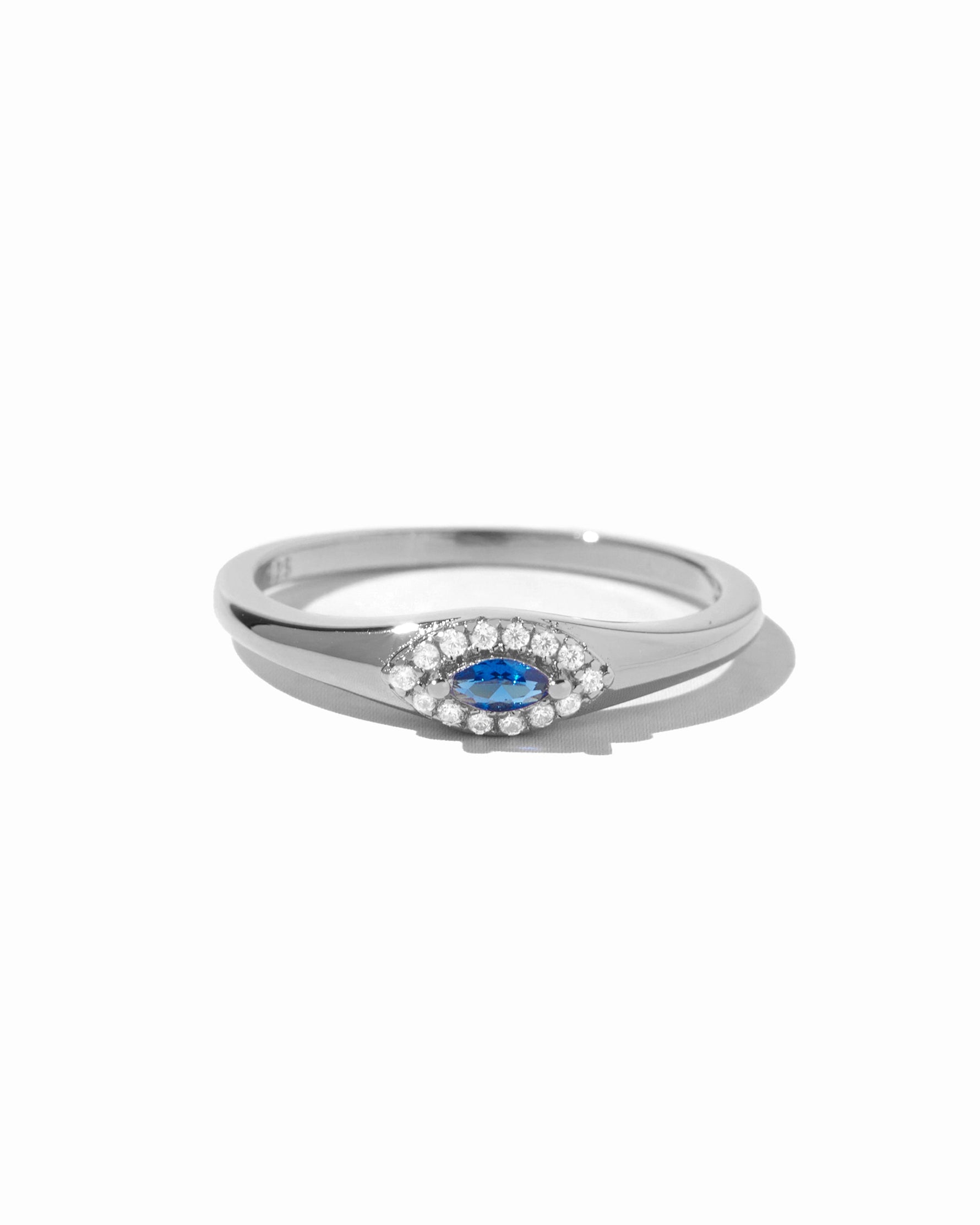 Sterling silver Sapphire Evil Eye Ring with blue gemstone accent, designed by Sami Jewels, on a white background.