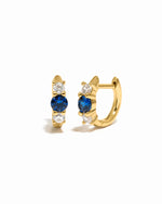 sapphire three stone huggie hoop earring gold white background
