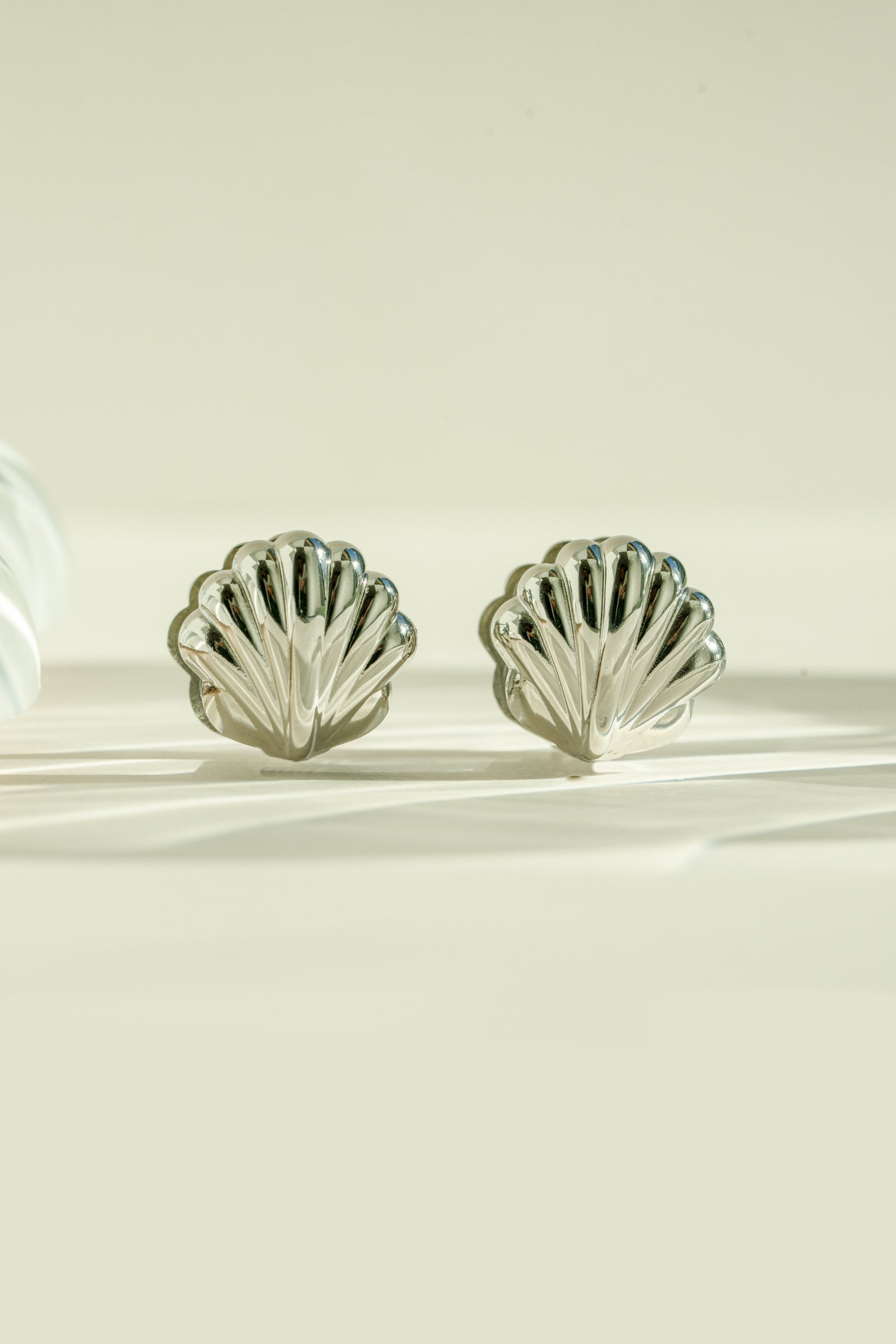 Silver stainless steel SS Shell earrings by Sami Jewels featuring a smooth, polished shell design with a waterproof finish.