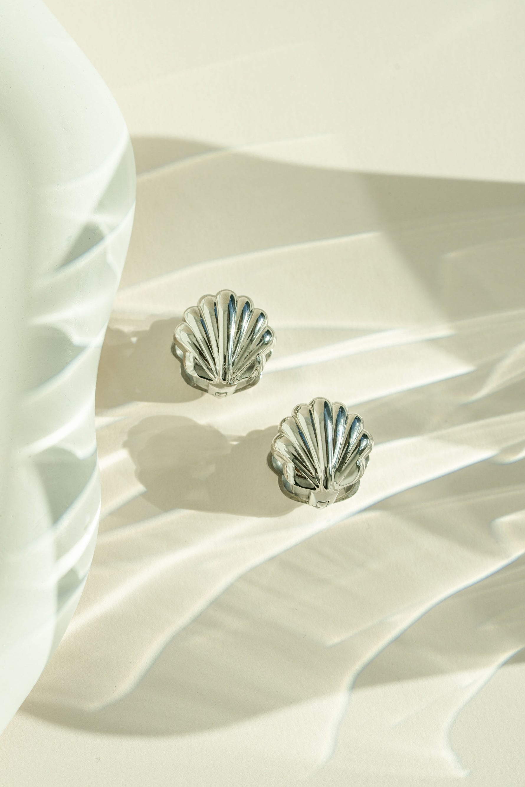 Silver stainless steel SS Shell earrings by Sami Jewels featuring a sleek, waterproof design with a shell motif.
