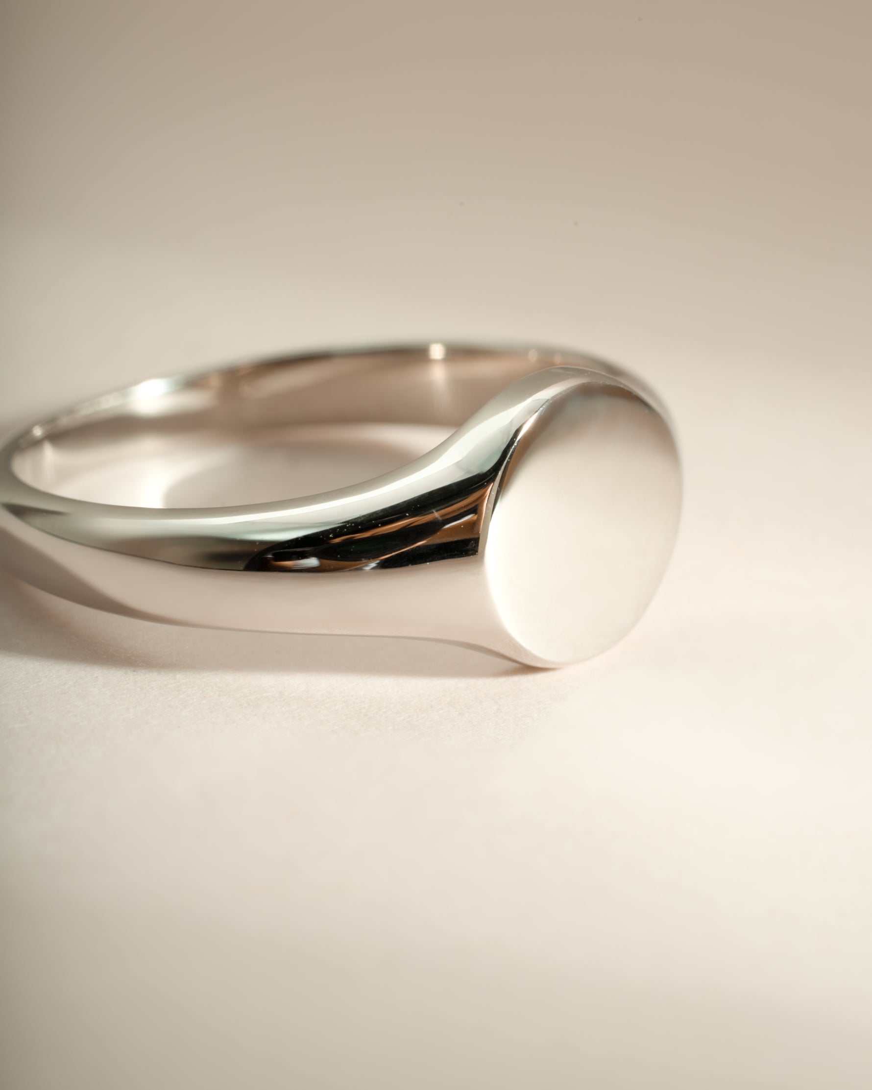 Close-up of a sterling silver signet ring from Sami Jewels featuring a polished, smooth surface and classic design.