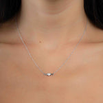 Model wearing silver pendant necklace with "MOM" pendant 