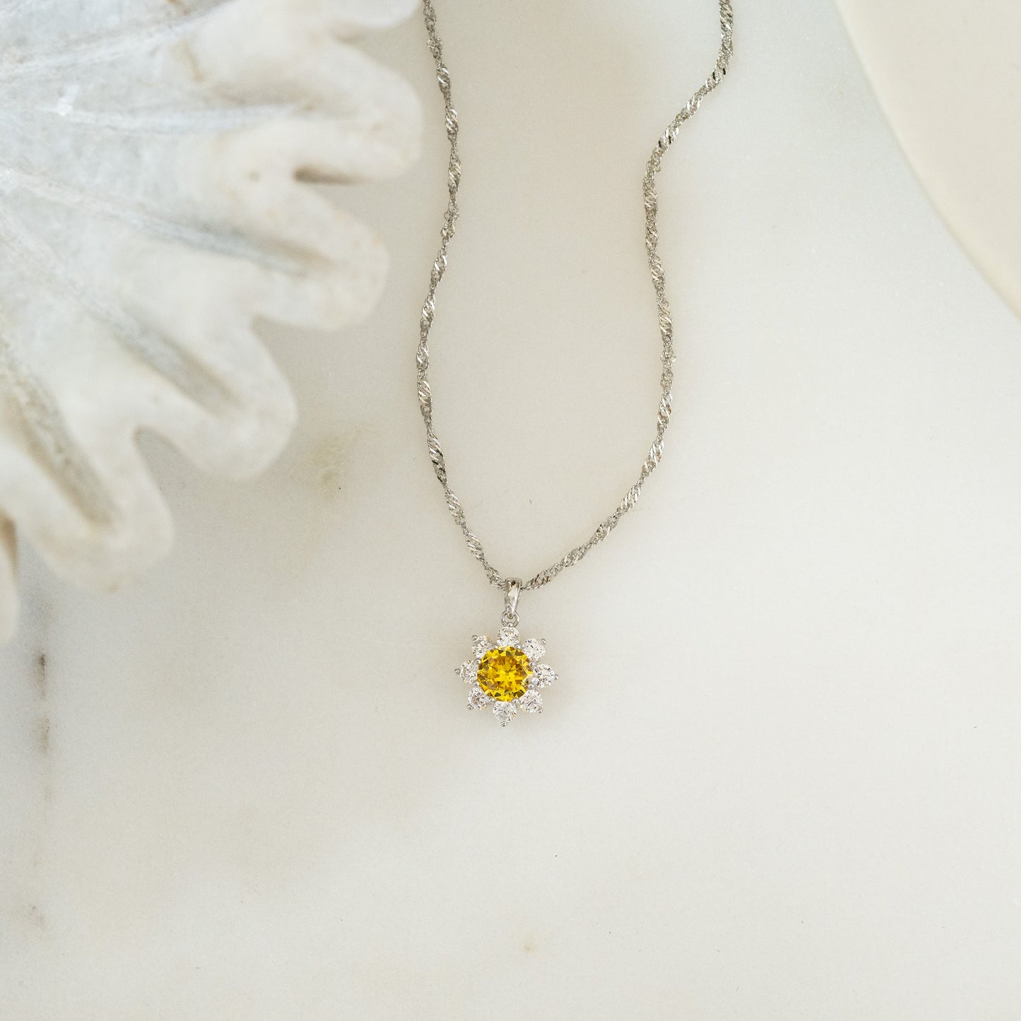 a sterling silver daisy pendant necklace on a rope chain