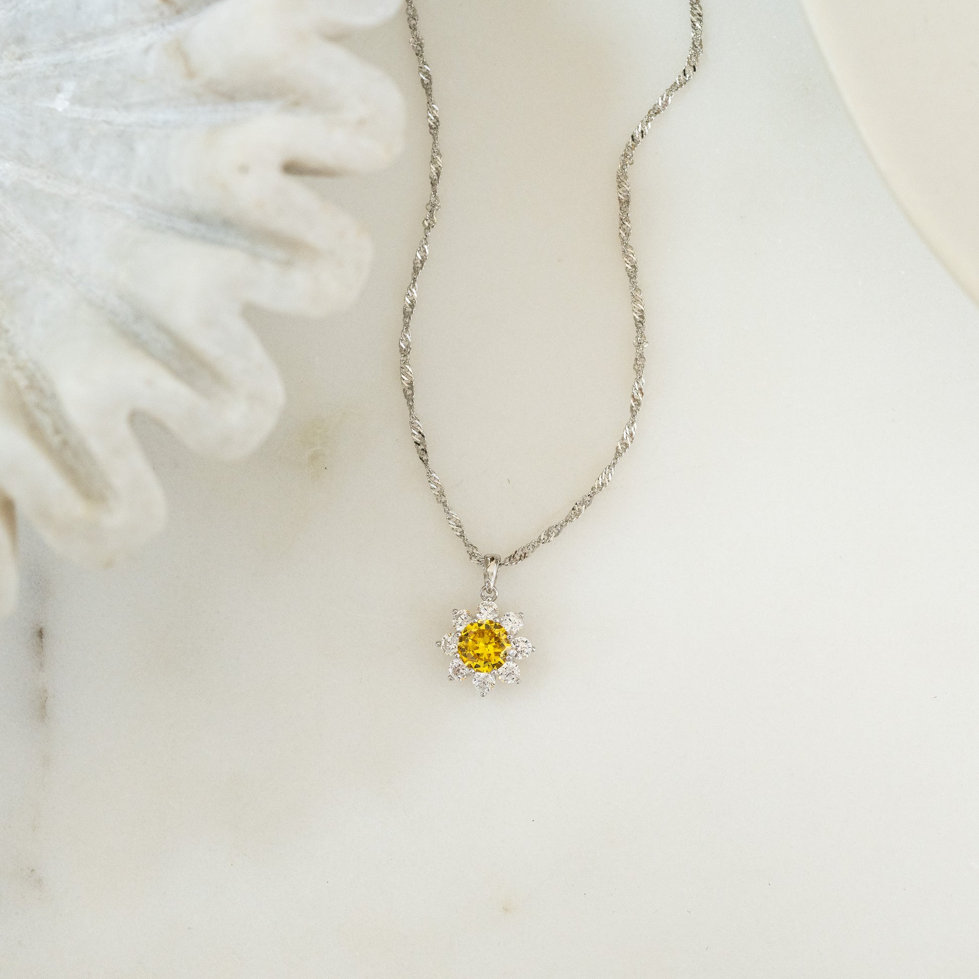 a sterling silver daisy pendant necklace on a rope chain