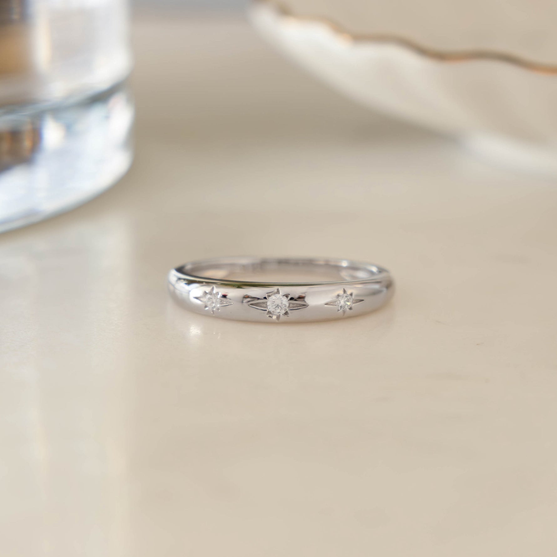 Sterling Silver Diamond Star Dome Ring on white marble background