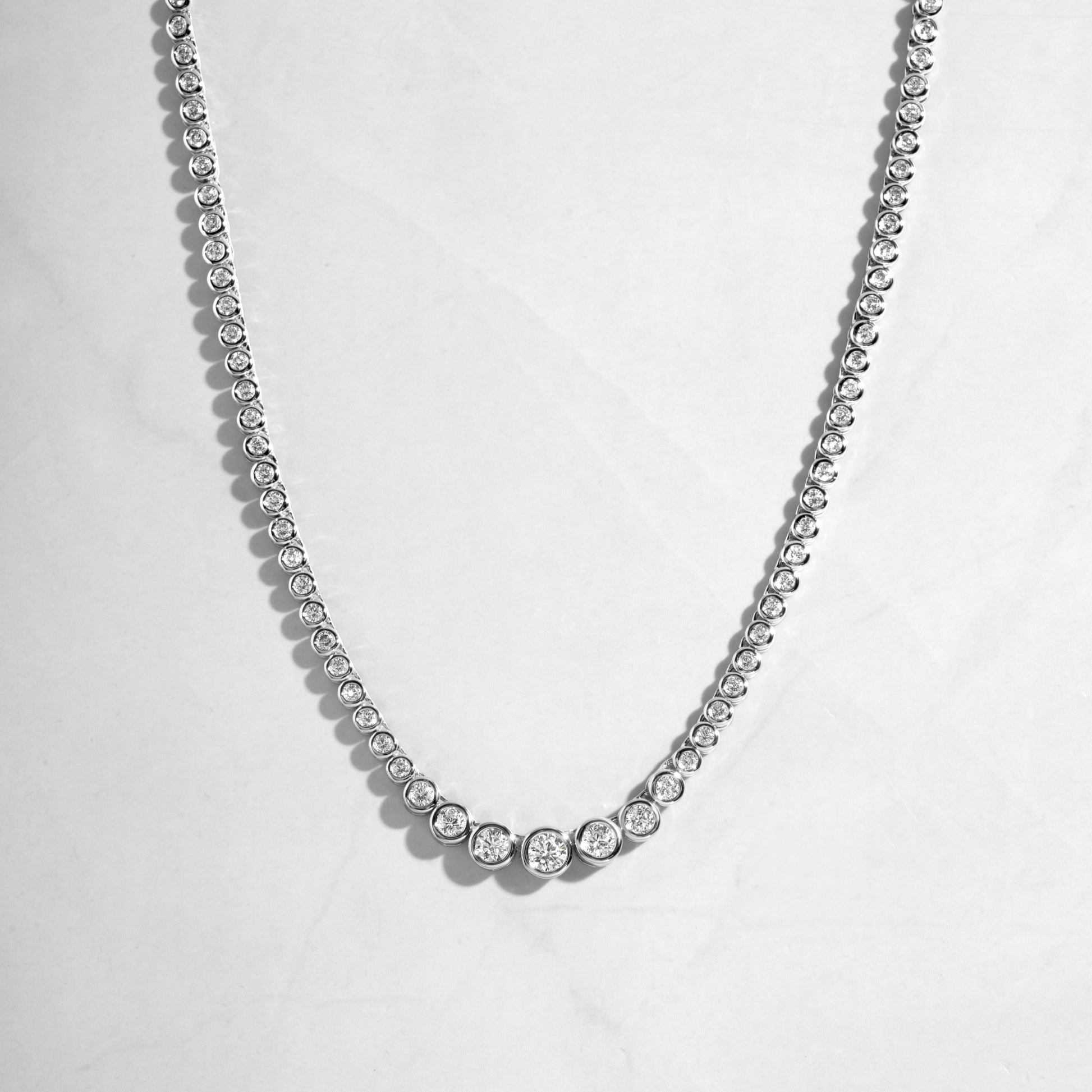 silver necklace with diamond tennis chain. 