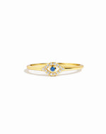 gold evil eye ring with a blue gemstone and cubic zirconia stones