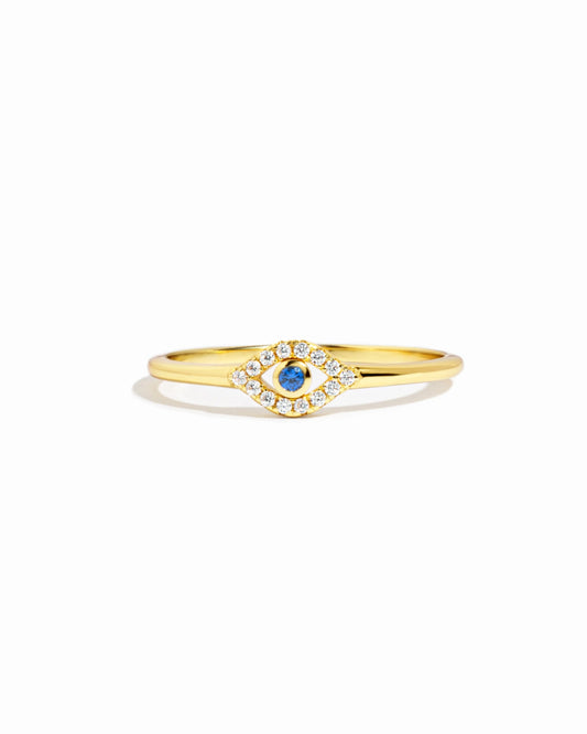 gold evil eye ring with a blue gemstone and cubic zirconia stones