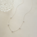 shiny, sparkly, sterling silver diamond necklace on white background