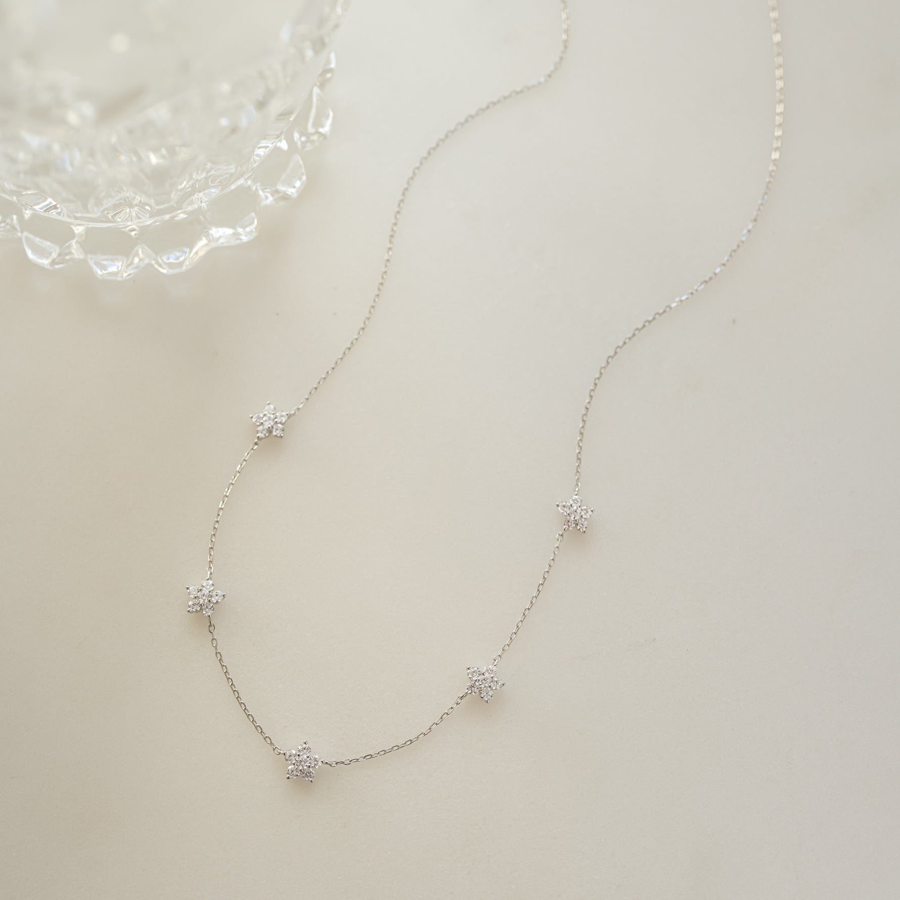 shiny, sparkly, sterling silver diamond necklace on white background