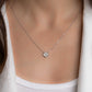 Model wearing a delicate four leaf clover pendant necklace in silver