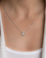 Model wearing clover pendant necklace in silver