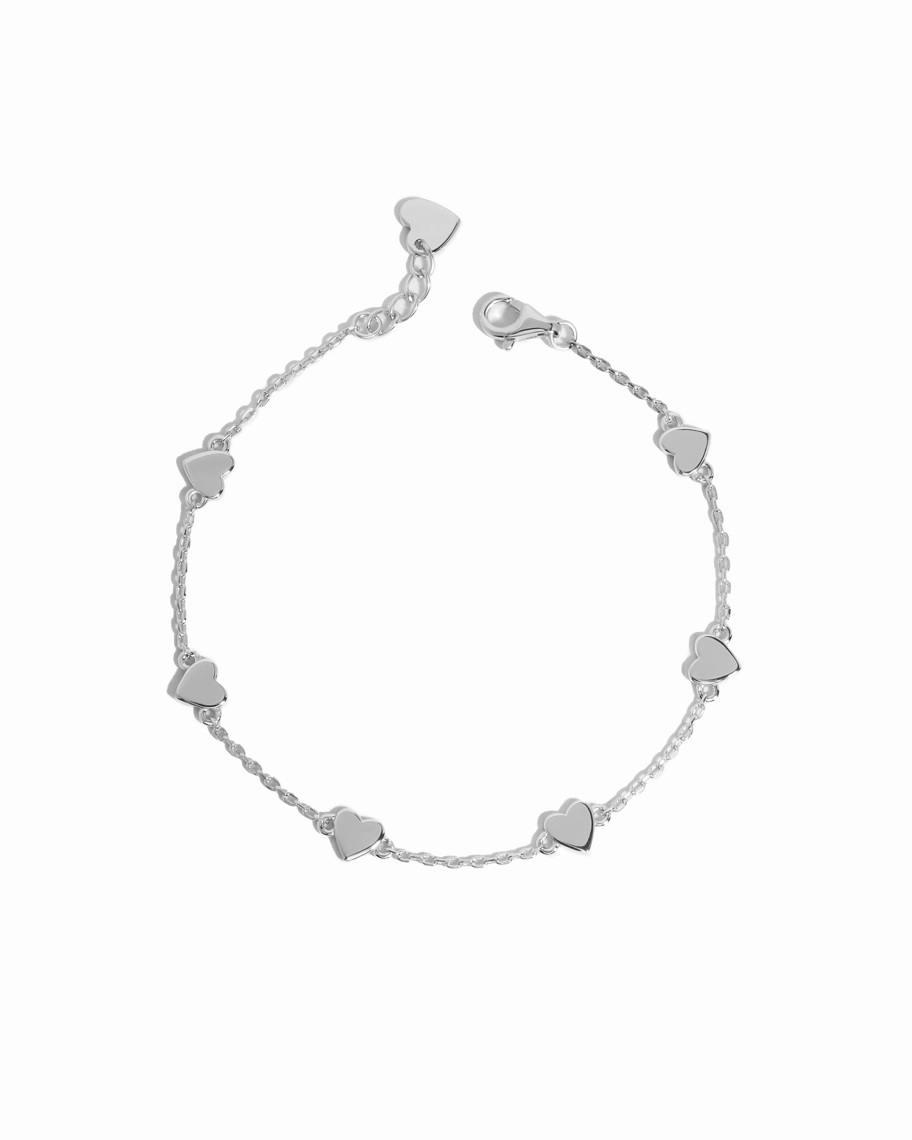 Close-up of heart bracelet in silver, showcasing its love charms and dainty chain, perfect for a minimalist look.