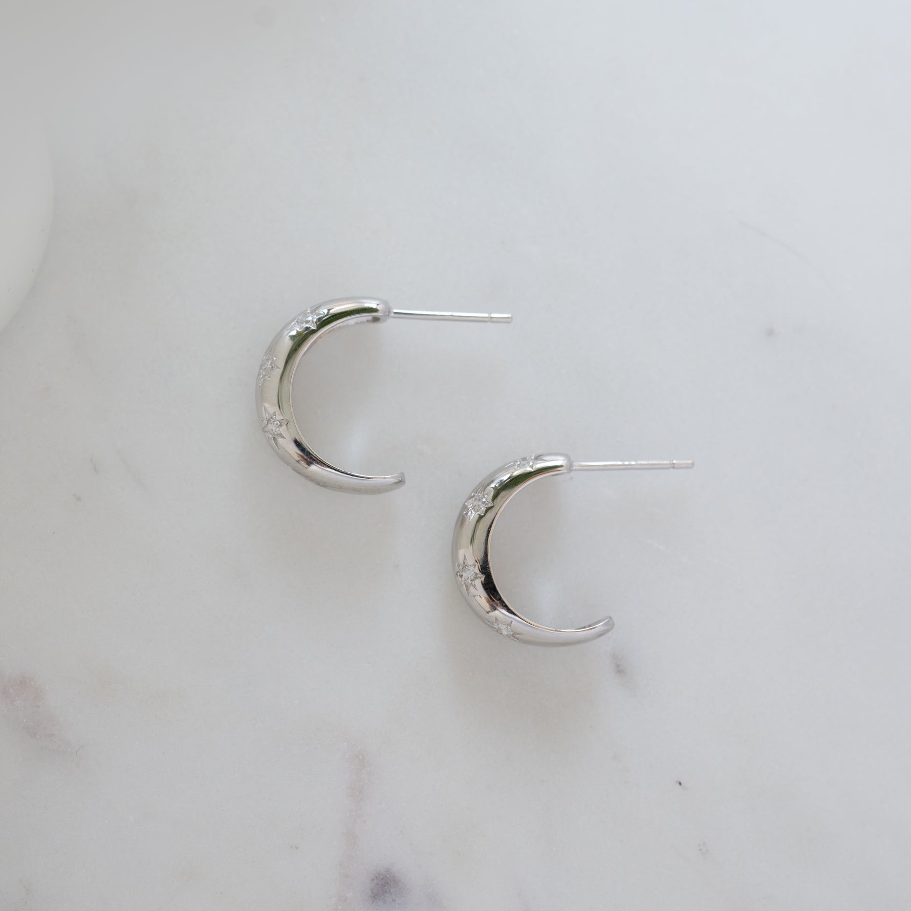 sterling silver hoop earrings with a celestial design