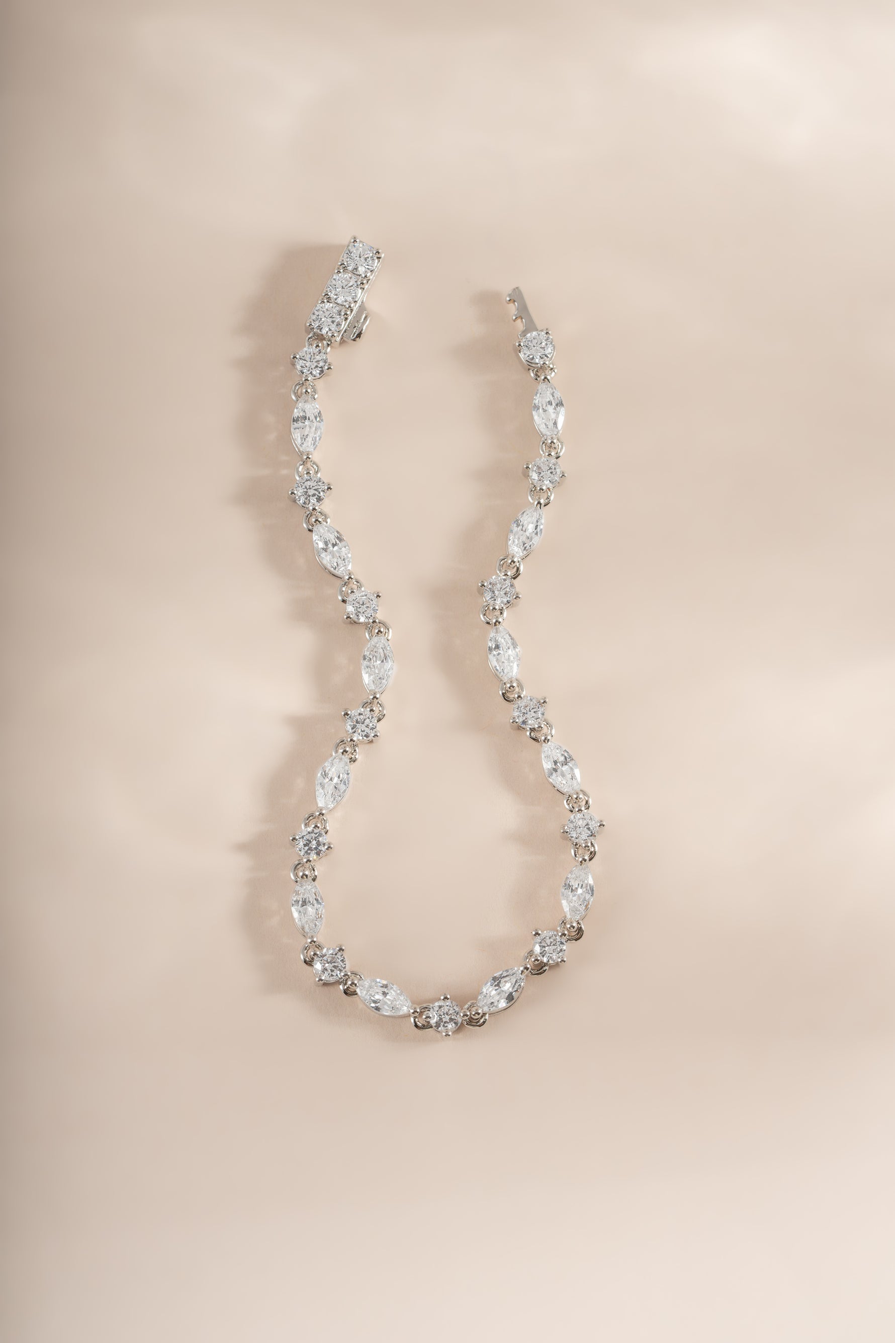 Silver bracelet with marquise and round cut diamond stones, Sami Jewels tennis bracelet displayed flat.