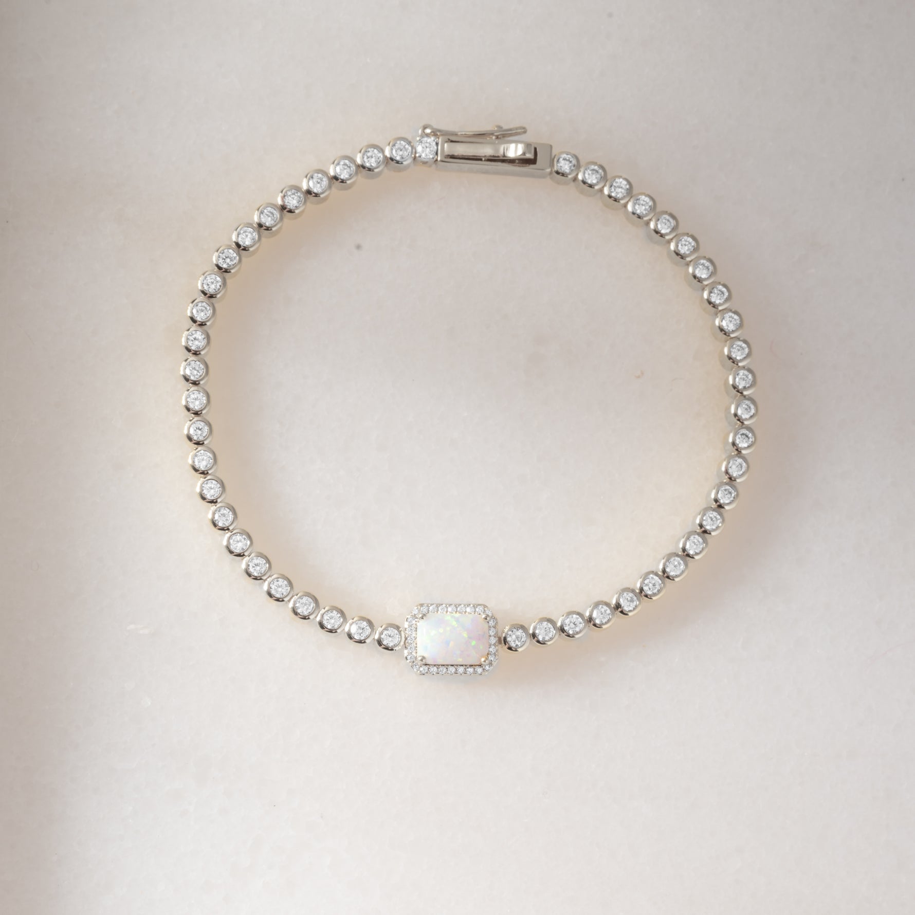 Silver Opal Baguette Tennis Bracelet by Sami Jewels featuring sleek silver design and sparkling opal baguette stones.