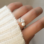 A model wearing Pearl Ring with Toi et Moi design se t in silver. 