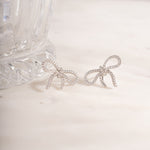 flat lay of silver diamond studs with its gemstones adding subtle and charming accent. 