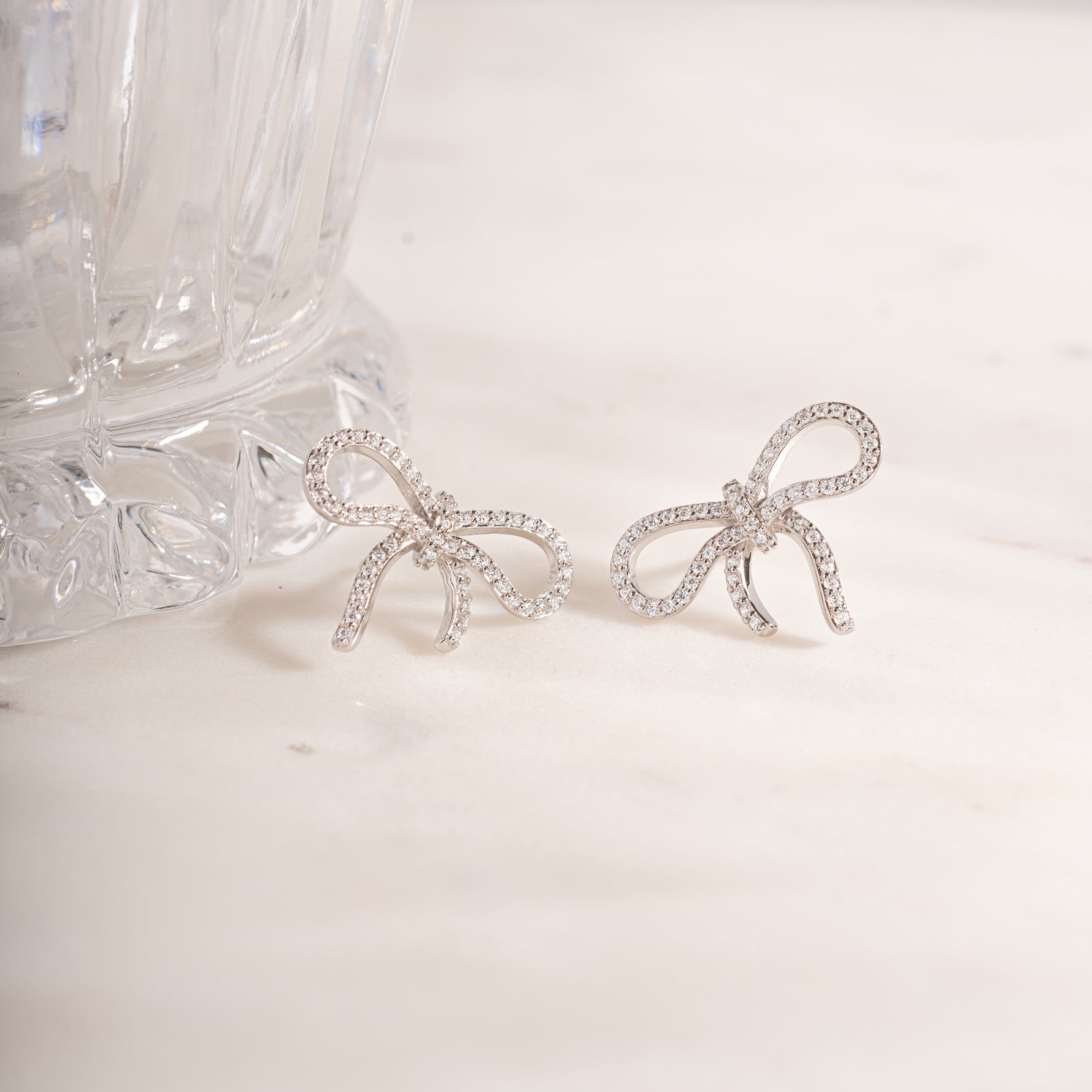 flat lay of silver diamond studs with its gemstones adding subtle and charming accent. 
