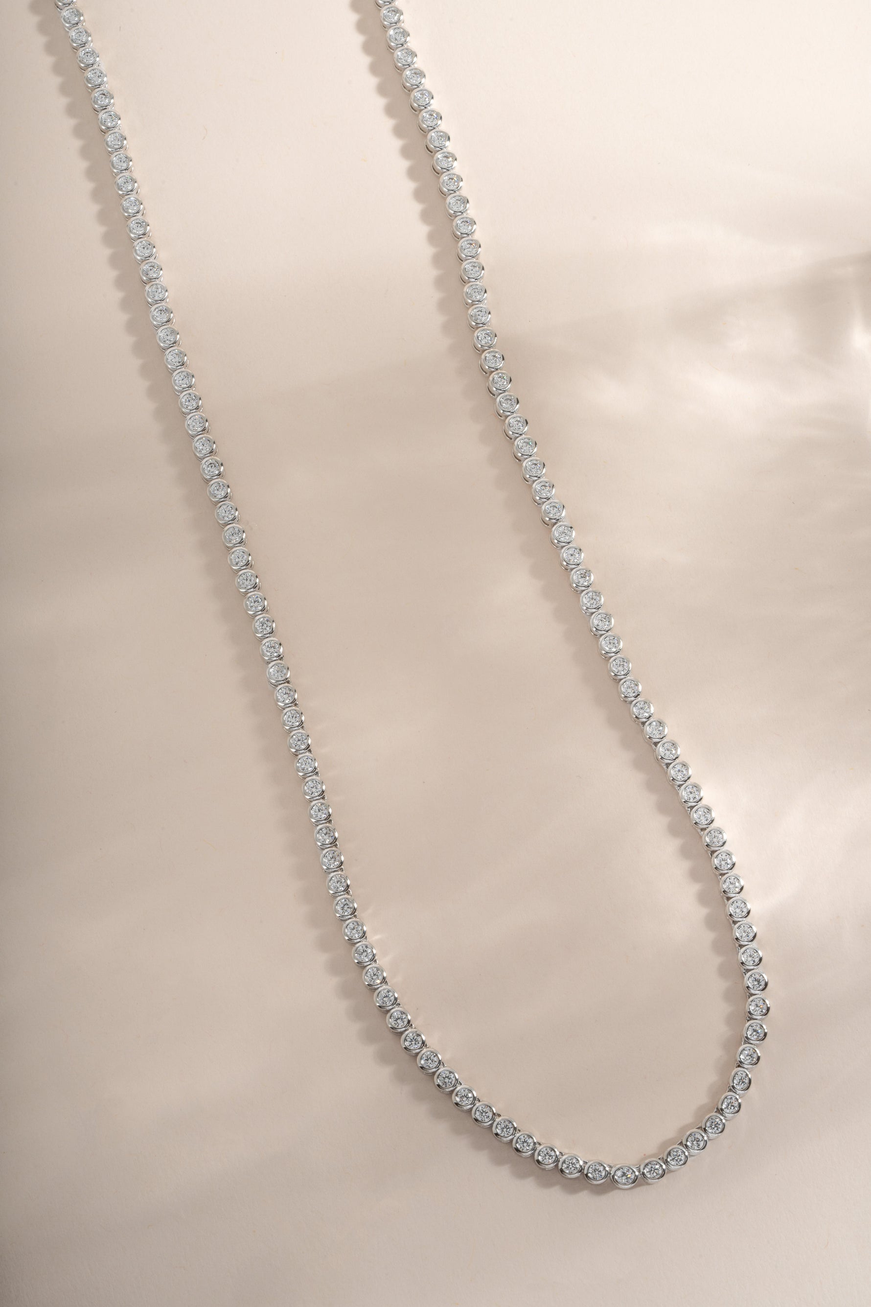 Silver round bezel tennis necklace by Sami Jewels, featuring a sleek, polished design with a smooth, round pendant.