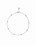 Bezel Set Station Anklet in silver finish, with round bezel-set stones, lobster clasp and heart-shaped end tag.