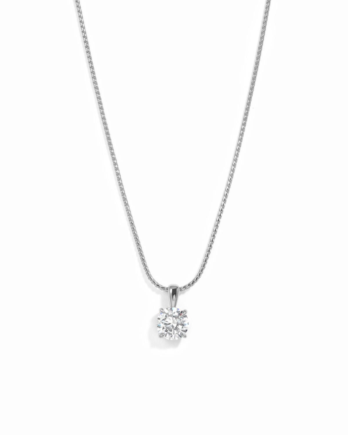 Silver round solitaire CZ pendant necklace on a white background.