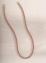 Silver Ruby Bezel Tennis Necklace by Sami Jewels featuring evenly spaced ruby gemstones along a sleek silver chain.