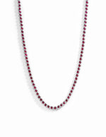 Silver Ruby Bezel Tennis Necklace by Sami Jewels featuring a row of sparkling rubies set in a sleek silver chain.