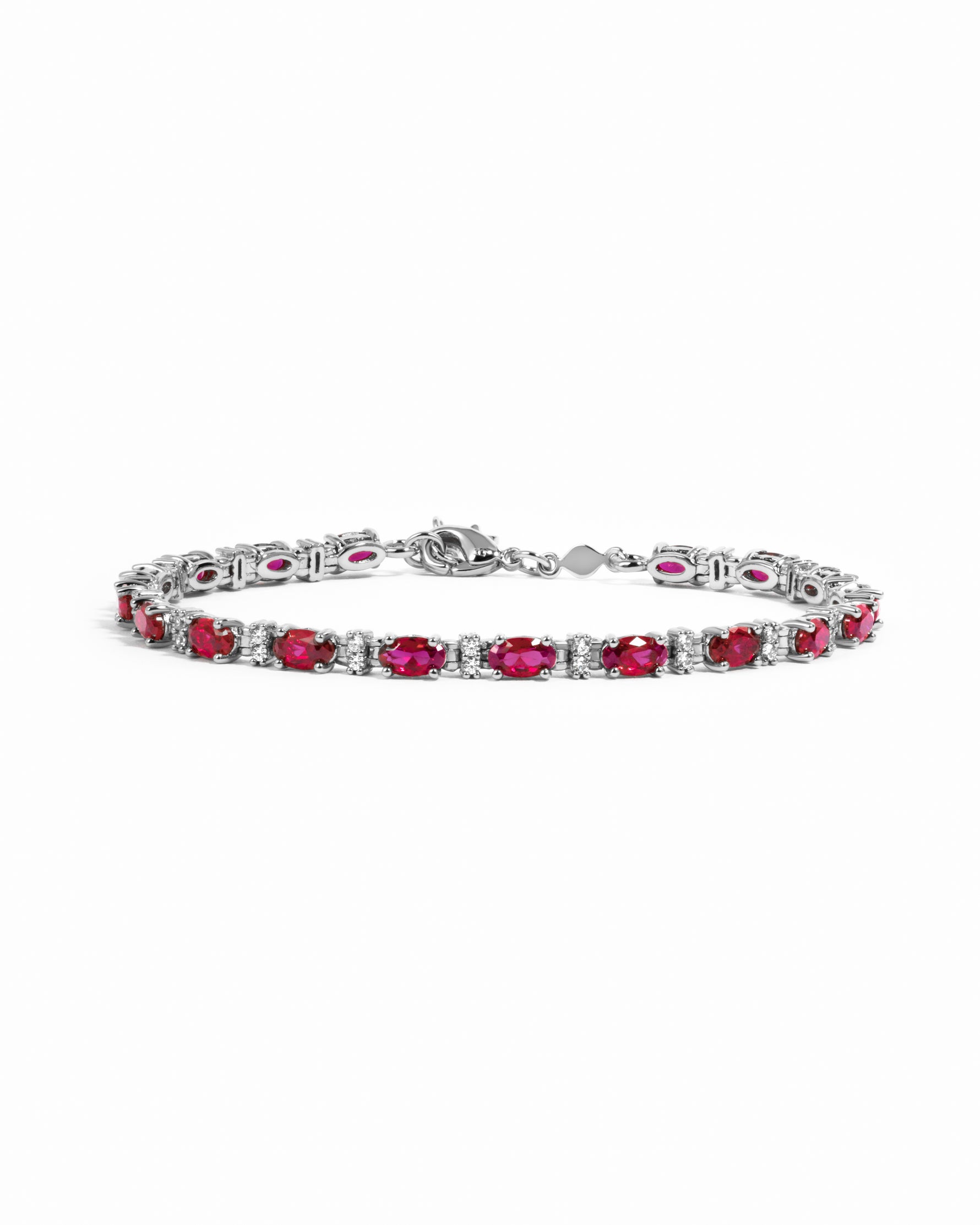 Silver Ruby Tennis Bracelet by Sami Jewels featuring sparkling diamonds and vibrant red rubies on a sleek bracelet.
