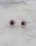 sterling silver flower studs with ruby center.