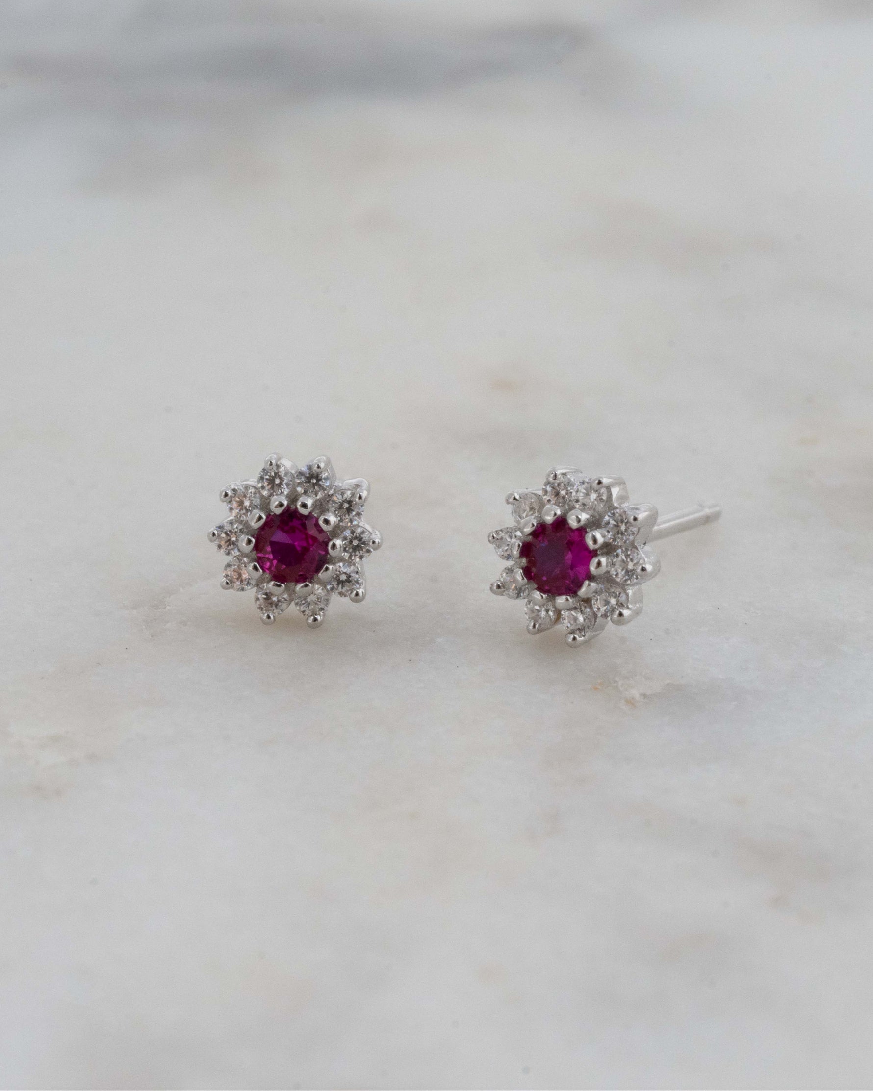 sterling silver flower studs with ruby center.