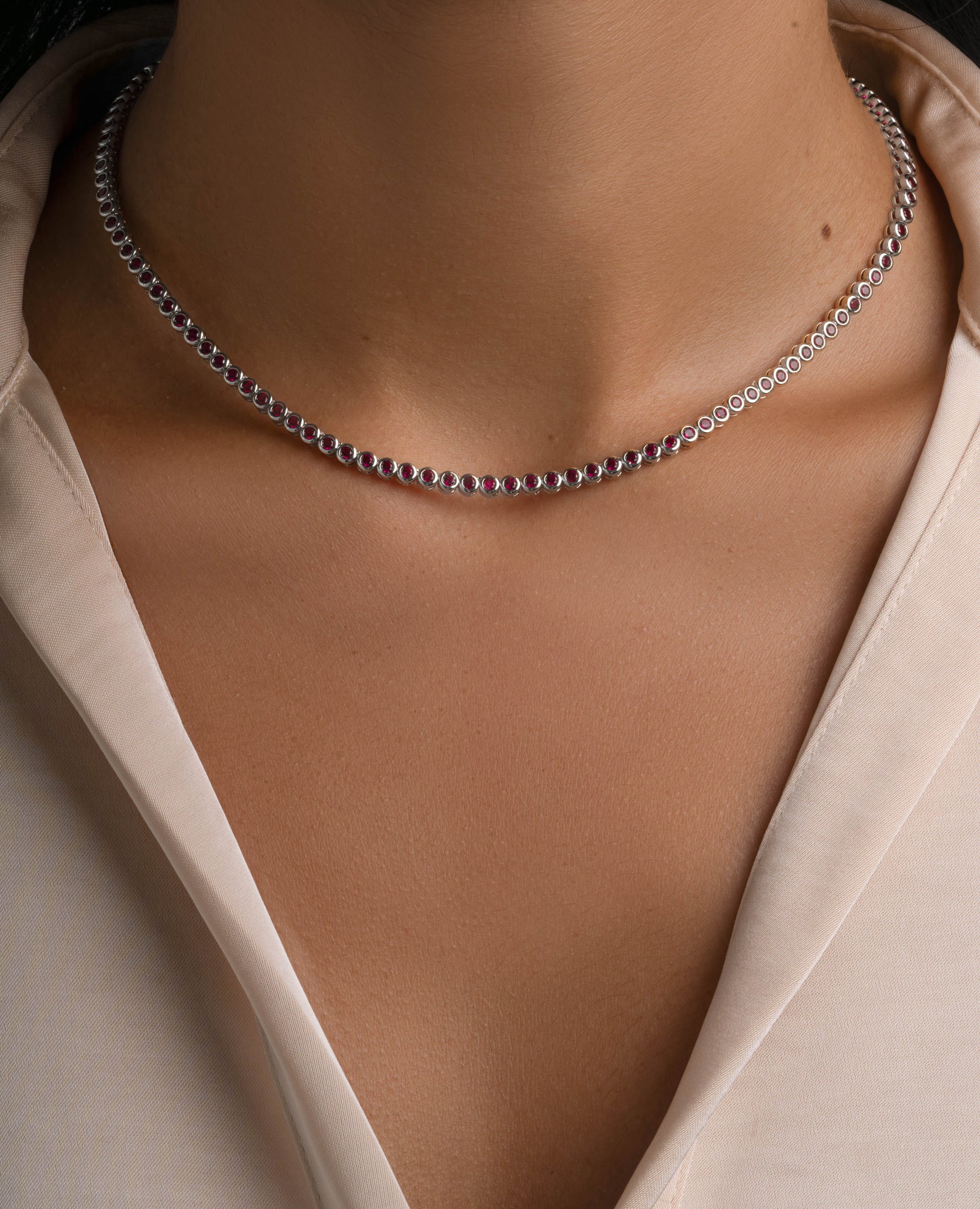 Silver Ruby Bezel Tennis Necklace by Sami Jewels worn on a model, showcasing a elegant gemstone choker style.