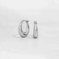 Silver chunky hoop earrings on white background