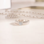 flat lay of a sterling silver ring, showcasing texture that feels like the delicate folds of a couture dress. 
