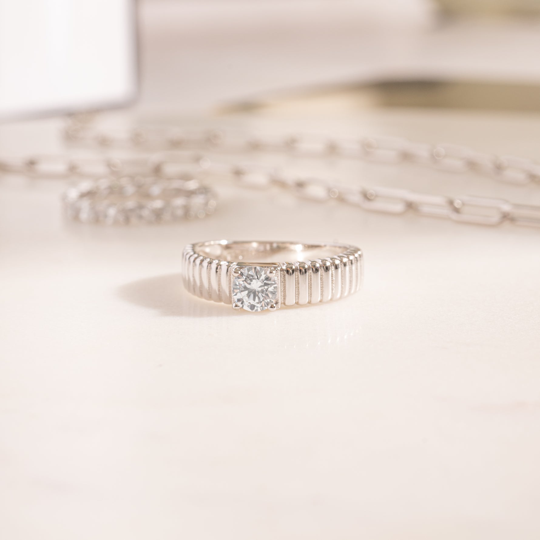 flat lay of a sterling silver ring, showcasing texture that feels like the delicate folds of a couture dress. 